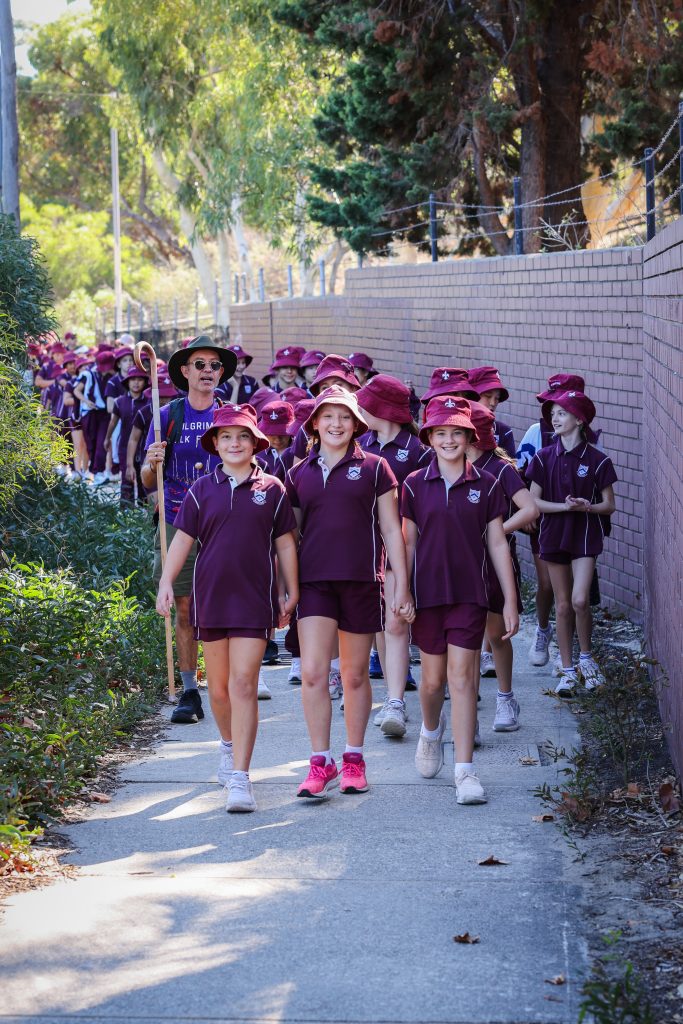 Junior School students walking with Bishop Hans